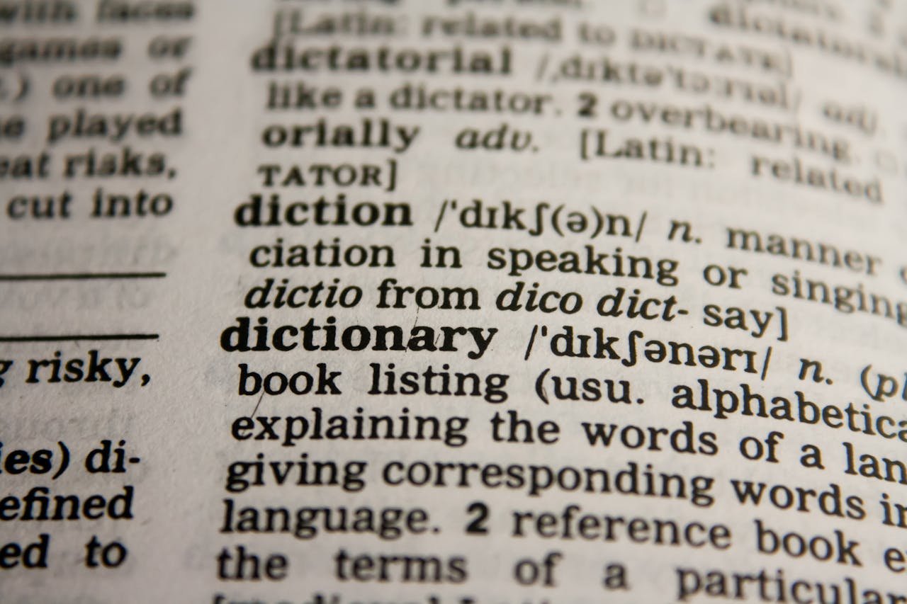 Detailed close-up view of a dictionary page highlighting the word dictionary and its definition.
